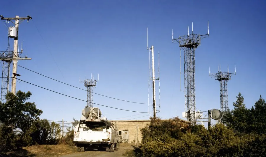 Communications towers and an equipment building on a hilltop