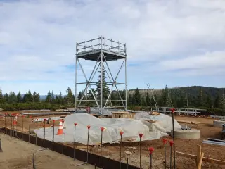 A steel equipment platform and lookout tower above a formed concrete vault under construction