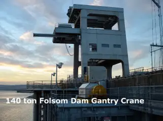 A large gantry crane standing on a dam crest at dusk, captioned 140 ton Folsom Dam Gantry Crane