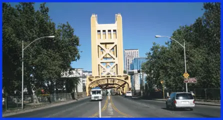 The Sacramento Tower Bridge seen head-on from the roadway, with traffic crossing